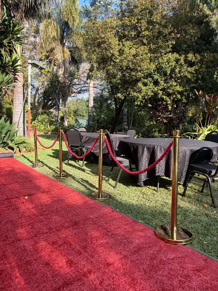 Black linen tables beside red carpet