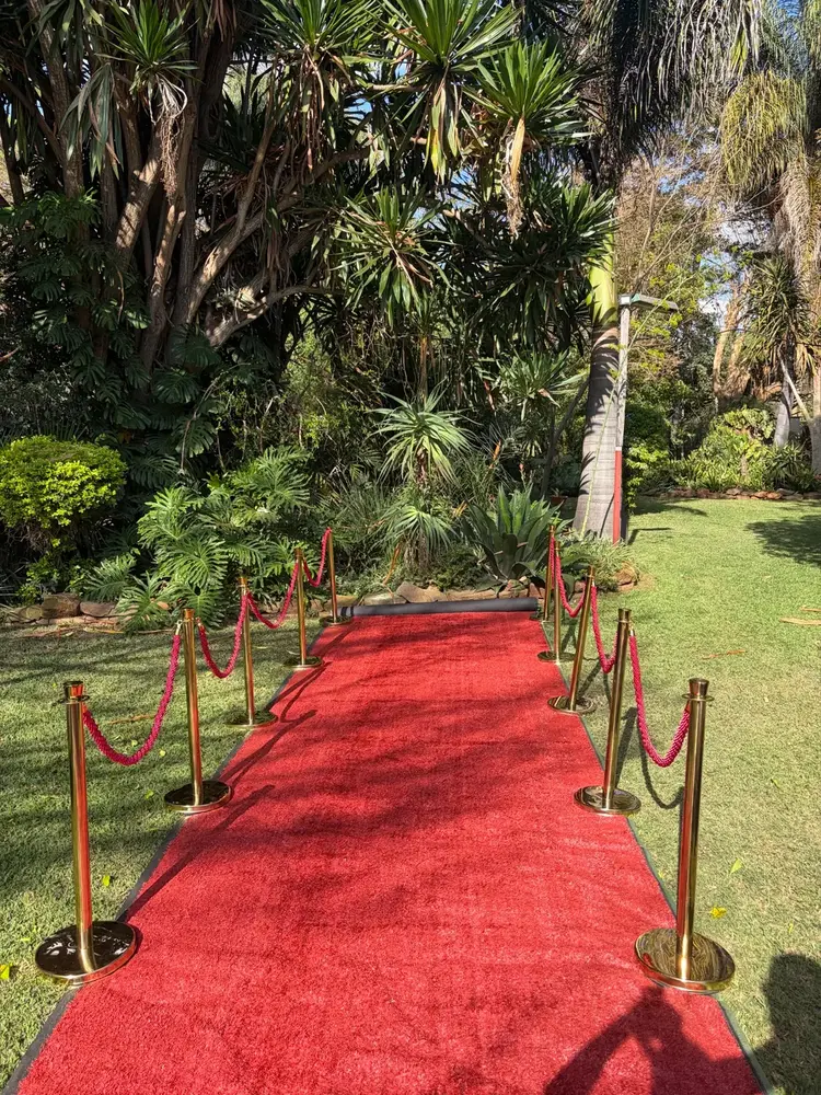 Red carpet with gold stanchions and red velvet ropes