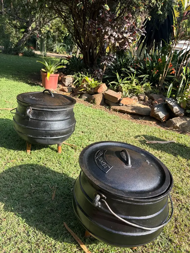 Large traditional cast iron cooking pots with lids