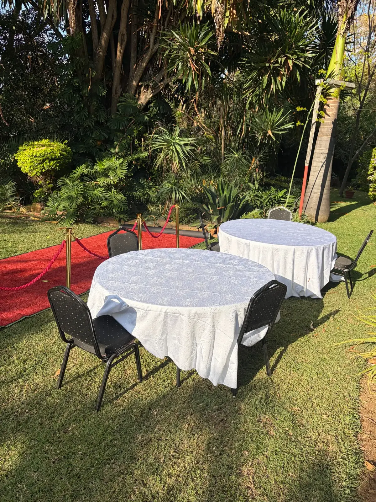 Round tables covered with plain white linen and no cutlery